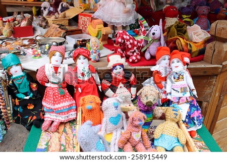 MOSCOW - MARCH 8, 2015: A free public art market on the pedestrian Arbat Street. Russians dolls. Rag and knitted dolls.