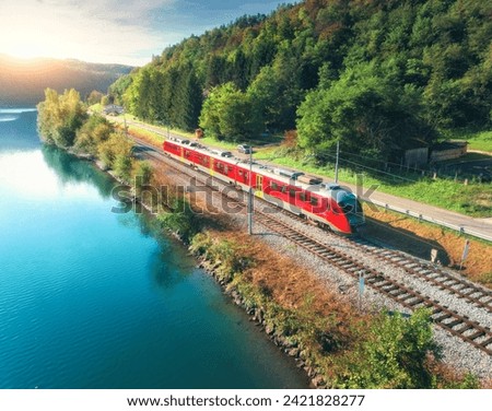 Similar – Foto Bild Roter Zug und Frühlingslandschaft bei Sonnenaufgang. Kontext der Frühjahrsreisen