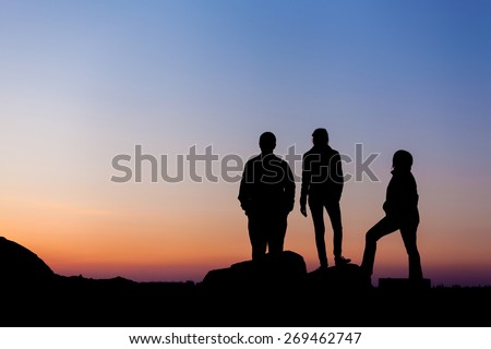 Silhouette of a happy family against the beautiful sky. Summer Sunset. Landscape