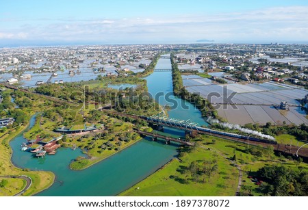 Similar – Image, Stock Photo Train on bridge amid lush plants in mountains