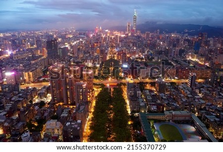 Aerial skyline of Taipei Downtown viewed from above Ren'ai Road, a wooded avenue in Taipei, Taiwan, with 101 Tower amid high-rise buildings in Xinyi Financial District and city lights dazzling at dusk 商業照片 © 