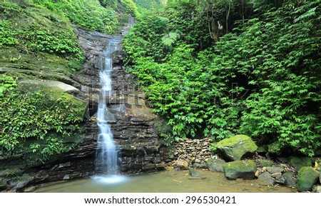 Cool refreshing waterfall hidden in a mysterious forest of lush greenery