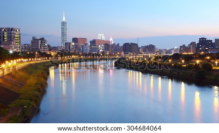 Panoramic aerial view of busy Taipei City, Taipei 101,  Keelung River and downtown area at dusk ~ A Blue and Gloomy evening in Taipei ~