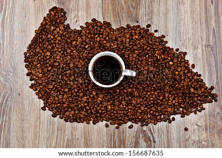 Cup of coffee in the coffee beans