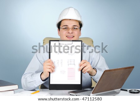 An engineer with white hard hat holding clipboard on gray background