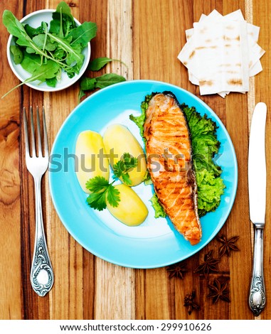 Grilled salmon on wooden background