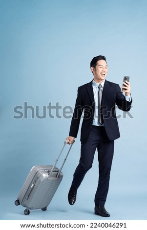 Similar – Image, Stock Photo Asian man with travel bag using smartphone against white wall