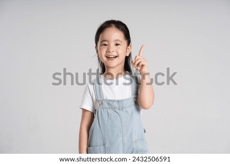 Similar – Image, Stock Photo Cheerful cute little girl showing modeling clay at camera