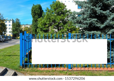 Blank white banner for advertisement on the fence. Residential area on a sunny summer day. ストックフォト © 