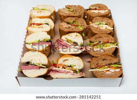 Sandwiches  in box on white background. Assorted delicious baguette sandwiches. Various kinds of sandwiches