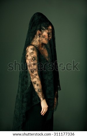 Portrait of a young girl in a veil. Sad crying woman at funeral. Portrait of a girl in montilla. Girl in mourning.
