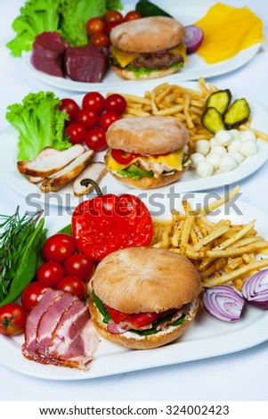 Fresh burgers in plate. Assorted delicious big hamburgers. Set of  different burgers in plate. burger ingredients