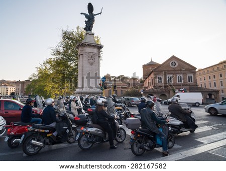 ROME - APRIL 17, 2013: Cars and motorcycles on the road from the bridge Ponte Vittorio Emanuele II across the Tiber river. Ospedale Santo Spirito (Hospital of the Holy Spirit). Rome, Italy.