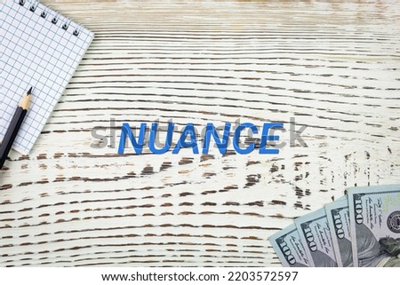 NUANCE - word (text) and dollars on a white wooden table, notebook, notepad. Business concept: buying, selling, commerce (copy space). Photo stock © 