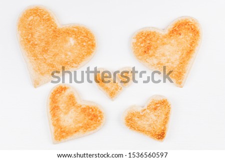Group of toasted bread hearts with one broken heart together on white background. The concept of support in big family. Foto stock © 
