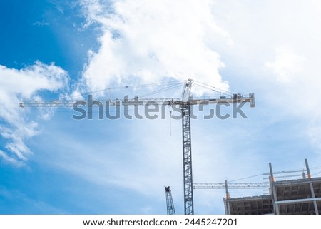 Similar – Image, Stock Photo Construction cranes with street lamp in front of a blue sky