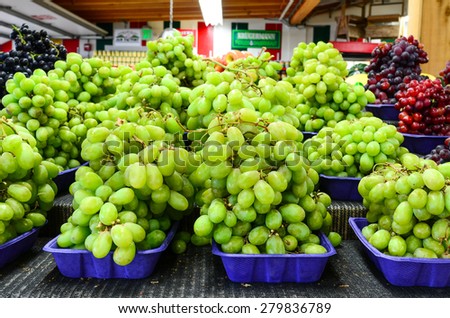 A stall of fresh organically grown black seedless, red and green grapes in the farmer market at Puyallup, Washington, USA.