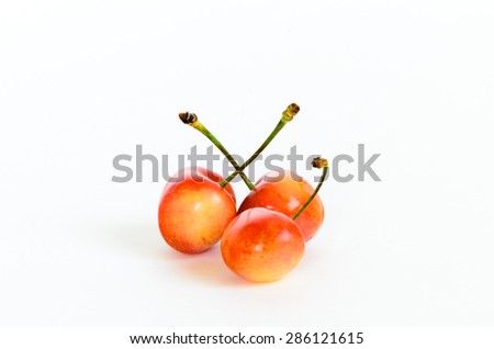 Three Rainier cherries on isolated white background. Rainiers are sweet cherries with a thin skin and thick creamy-yellow flesh. Panoramic style.