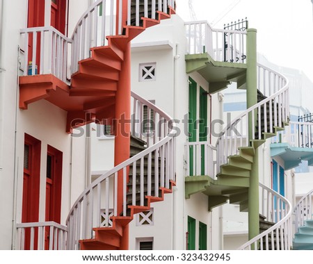 Colorful spiral staircases at the back of traditional Chinese shop houses in Bugis Village, Singapore. Colorful urban and cityscape concept