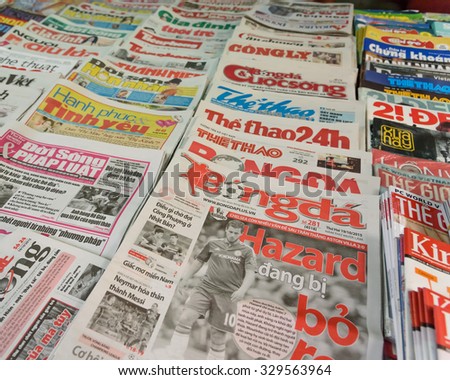 HANOI, VIETNAM - OCT 19, 2015: A newsstand with many daily newspapers on the sidewalk of a street in Hanoi capital. Vietnam has more than 600 state owned newspapers and media agencies