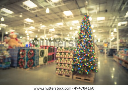 blurred image huge christmas tree decoration in wholesale store wreaths and strings of bokeh light - Wholesale Vintage Christmas Decorations blurred image huge christmas tree decoration in wholesale store wreaths and strings of bokeh light - Wholesale Vintage Christmas Decorations