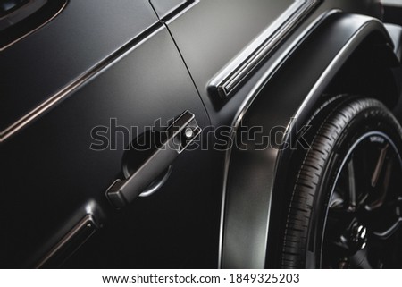 middle shot of a luxury car door handle in matt black ストックフォト © 