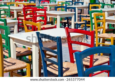 A picture of colorful chairs outside a restaurant