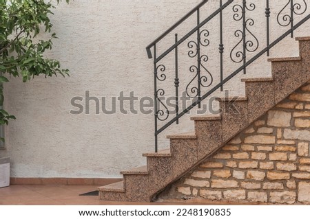 A ladder and forged railing in one of the private houses. Stock fotó © 
