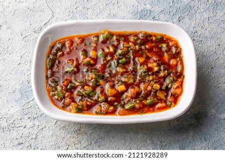 A spicy Turkish appetizer ezme made with tomatoes, bell pepper, parsley, mint, olive oil and hot chili.  Stok fotoğraf © 
