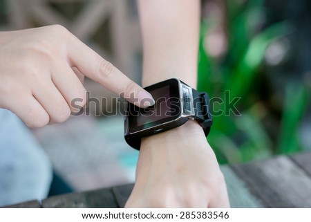 A Female(woman) finger on her smart watch