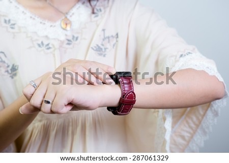 A female(woman) looking at her smart watch