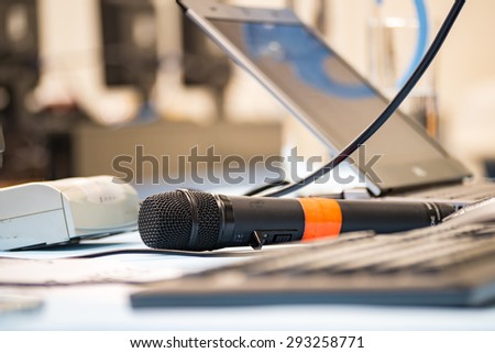 Microphone in training room with blur computer.