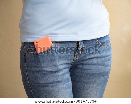 Smart phone in pocket of girl\'s jeans