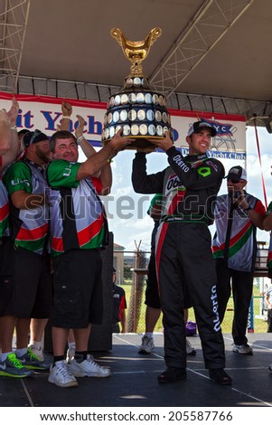 DETROIT - JULY 13: Jimmy Shane wins the Gold Cup Trophy at the APBA Gold Cup July 13, 2014 on the Detroit River in Detroit, Michigan.