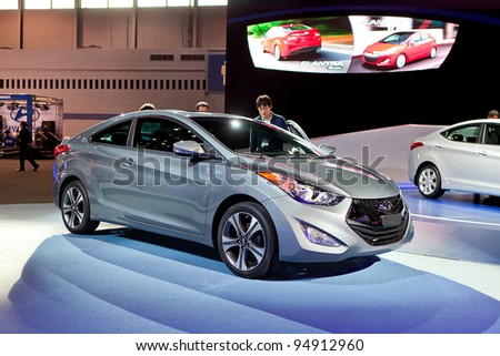CHICAGO - FEB 8: Visitors look at the new Hyundai Elantra Coupe at the 2012 Chicago Auto Show Media Preview on February 9, 2012 in Chicago, Illinois.
