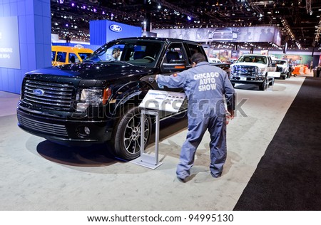 CHICAGO - FEB 8: Workers prep the cars for the show opening on display at the 2012 Chicago Auto Show Media Preview on February 8, 2012 in Chicago, Illinois.