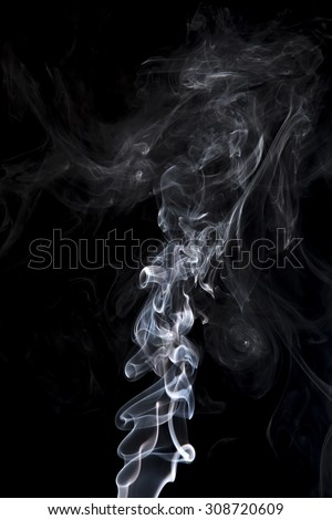 gray smoke on a black background. Shot in studio