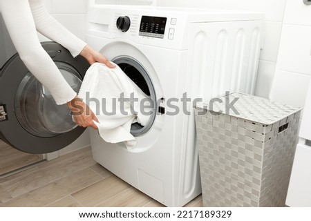 Similar – Image, Stock Photo Getting laundry out of the washing machine