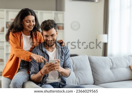 Similar – Image, Stock Photo Couple using a mobile phone while having breakfast together at home.