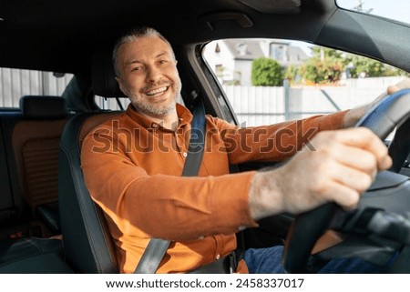 Similar – Image, Stock Photo Man sits in car and looks seriously out the window