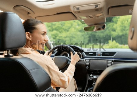 Similar – Image, Stock Photo Traveler driving car on country road through winter forest