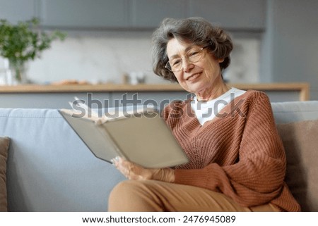 Similar – Image, Stock Photo Woman reading a book in cafe sitting at wooden table with flowers in a vase. Romantic date with a book. Brown vintage neutral color background. Literature & Library, book lover spending leisure time.