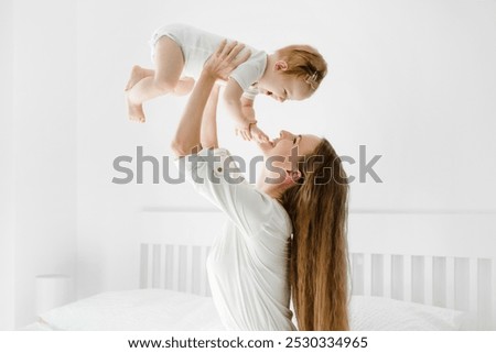 Similar – Image, Stock Photo Young baby sitting in high chair looking towards window; interior of home with vintage furniture