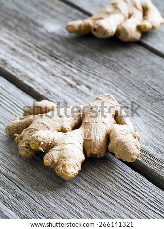 Fresh dry ginger on dark wooden background