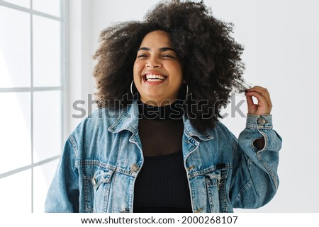 Similar – Image, Stock Photo Happy plus size curly young woman smiling to camera while using a laptop to prepare,and do work online at home, remote tasking. Modern city flat. Getting the bills paid. Entrepreneur freelancer women