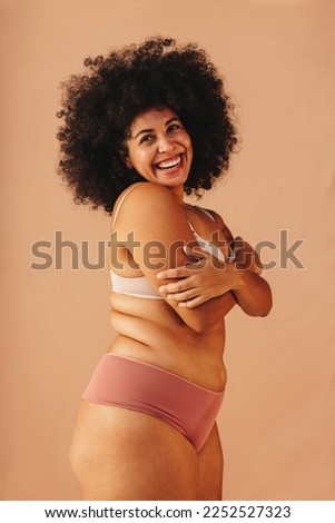 Image, Stock Photo Happy plus size curly young woman smiling to camera while using a laptop to prepare,and do work online at home, remote tasking. Modern city flat. Getting the bills paid. Entrepreneur freelancer women