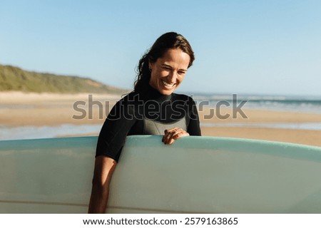 Similar – Image, Stock Photo Female surfer standing at the beach with surfboard