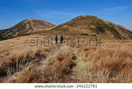 Travelers in the mountains. Autumn hiking in the Carpathian mountains