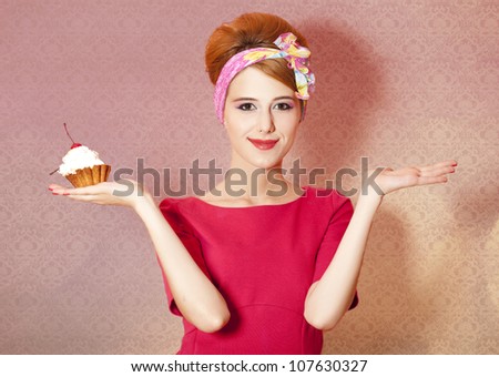 Style redhead girl with cake at pink background.