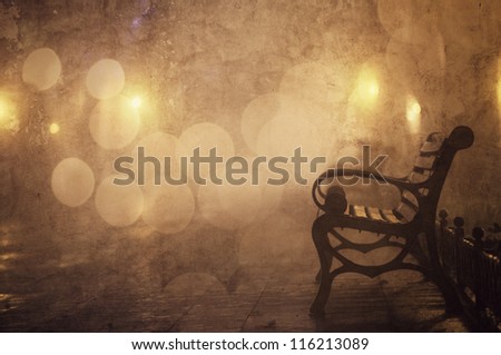 Bench in night alley with lights in Odessa, Ukraine. Photo in retro style.